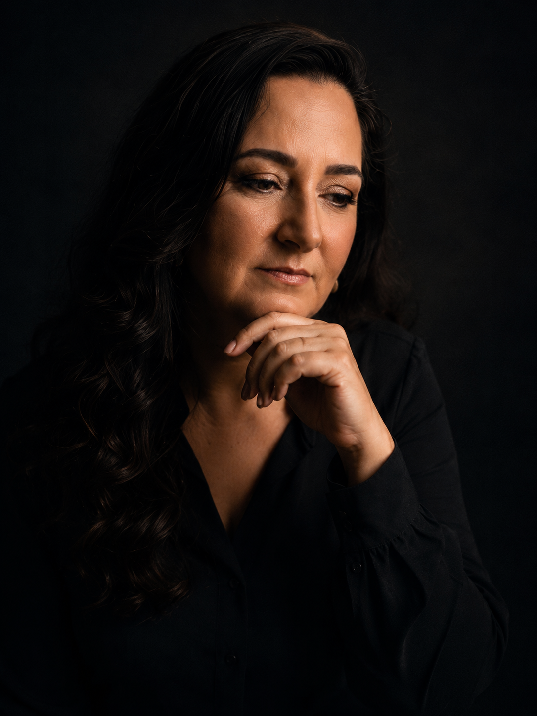 Ellen Maldonado em retrato reflexivo, fundo escuro